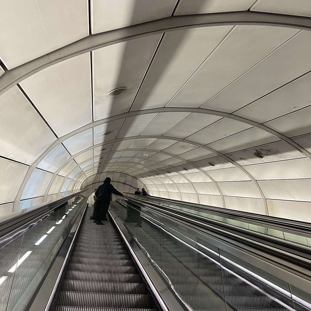 A person on an escalator in perspective