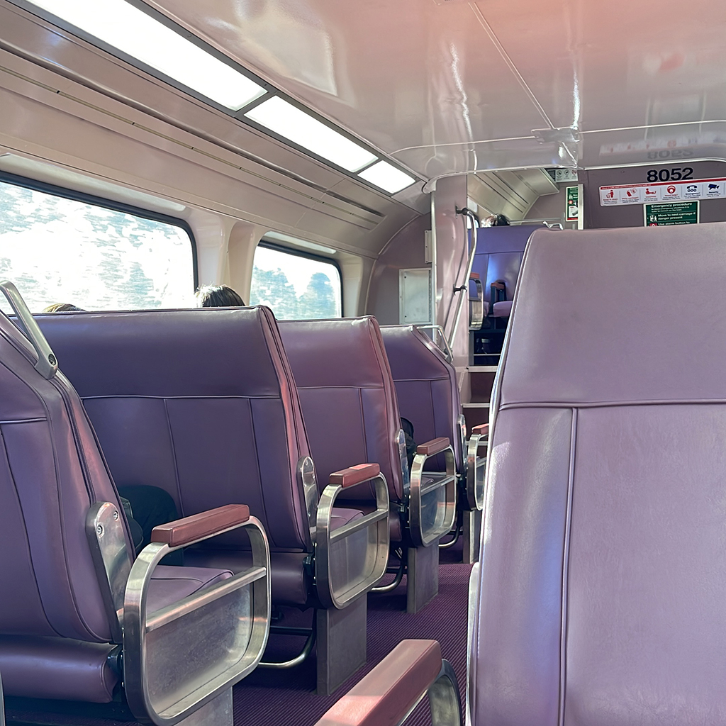 A picture containing passenger seat in a cabin.